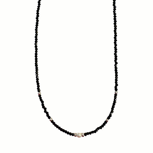 Black Beaded Necklace with Pearl Accents draped on a jewelry bust