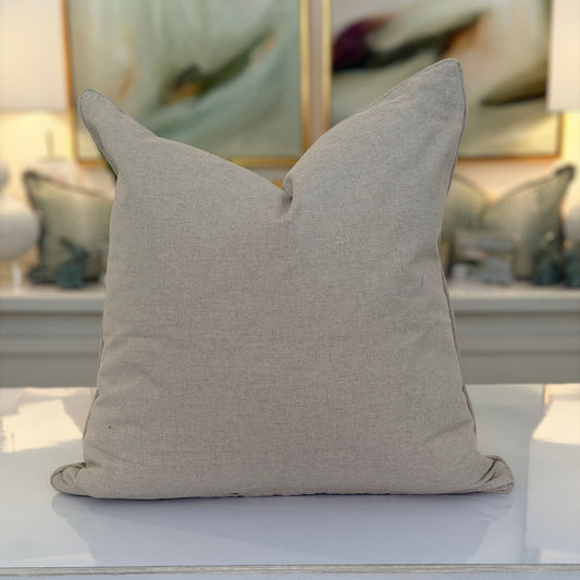 The plain taupe linen back of the green leopard print pillow.