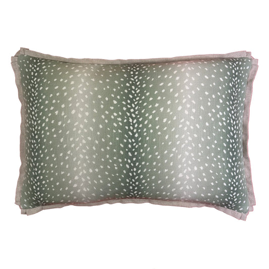 Green and white Erindi Fern lumbar pillow, styled on a sofa