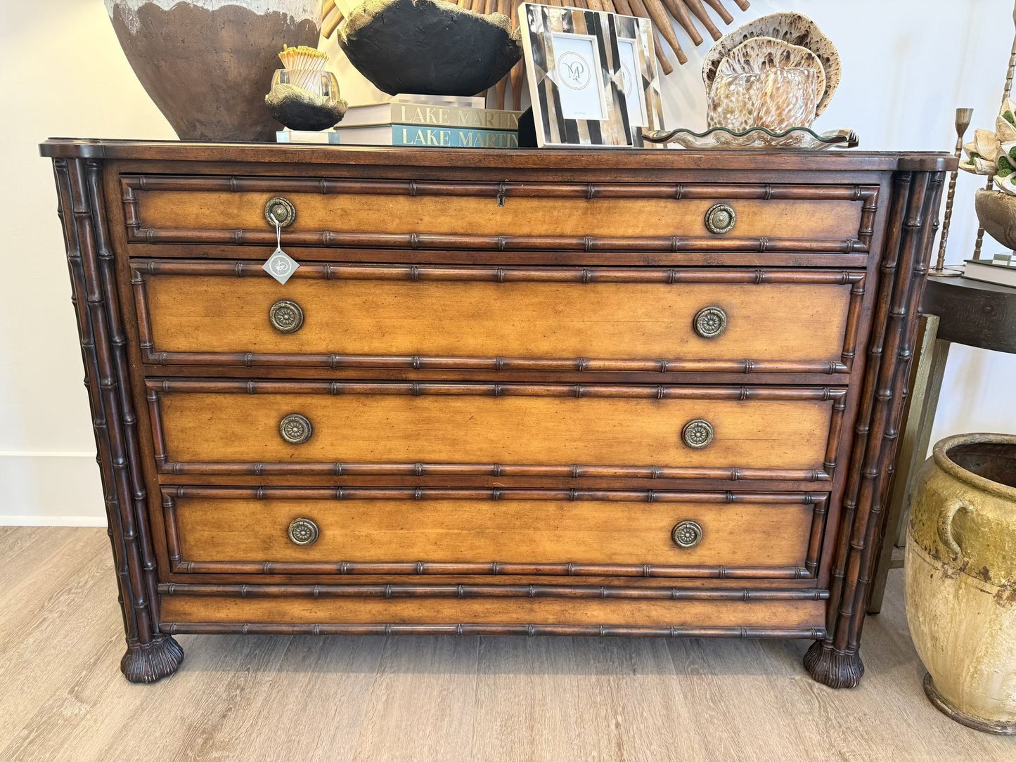 Wooden dresser with decorative items on top in a room setting