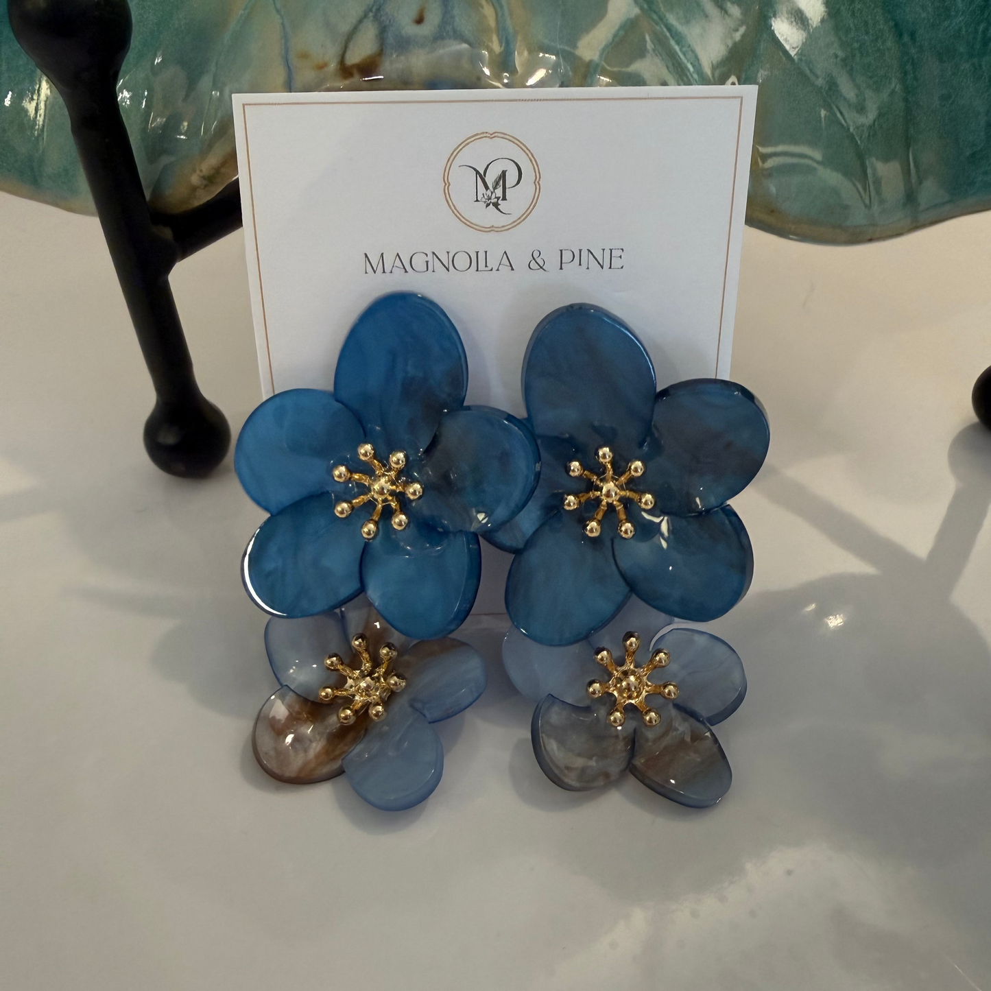 Layered Floral Dangle Earrings in blue, on card