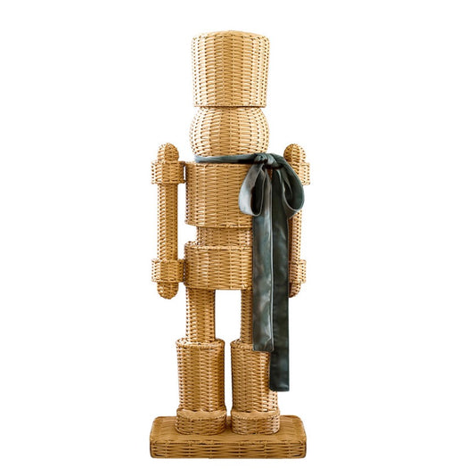 A handwoven rattan nutcracker in green, close-up detail view.