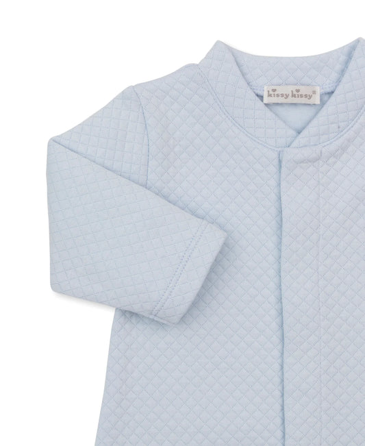 Close up of light blue convertible baby gown with a brand label on a white background