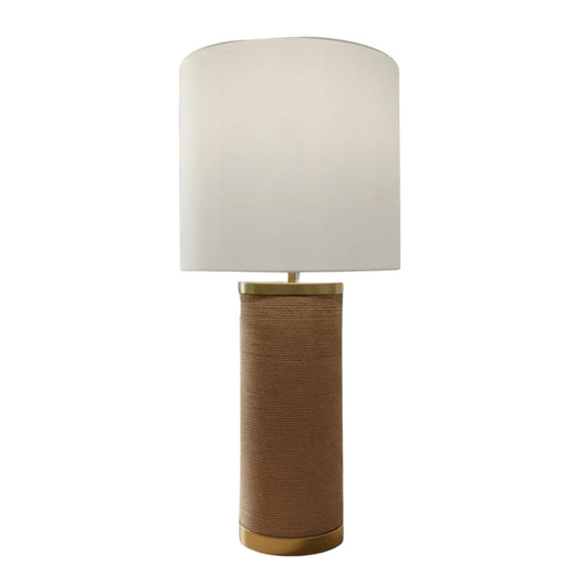 Close-up of a table lamp with a natural abaca rope-wrapped base and polished gold accents at the neck and base.