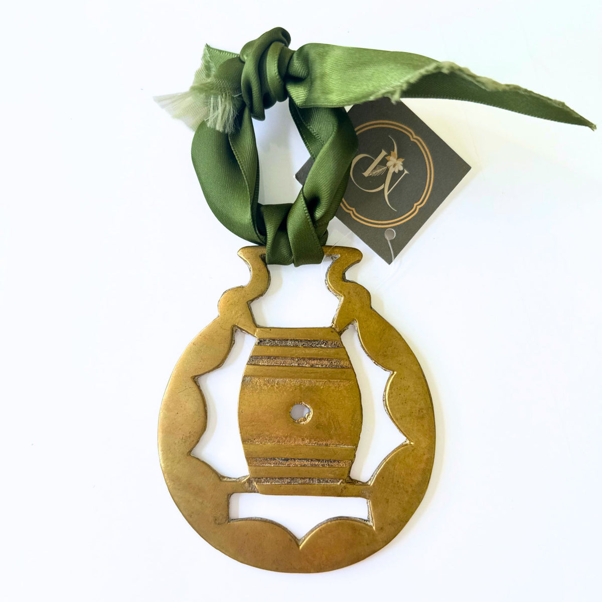 Vintage brass medallions tied with ribbon, styled on a tray