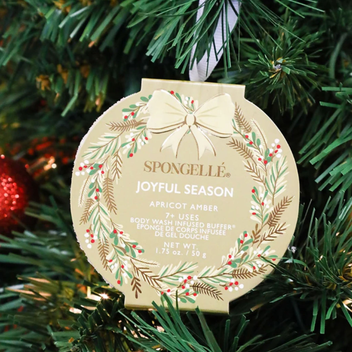 A white wreath-shaped 'Holiday Splendor' body buffer box with a cream ribbon, labeled Golden Pear