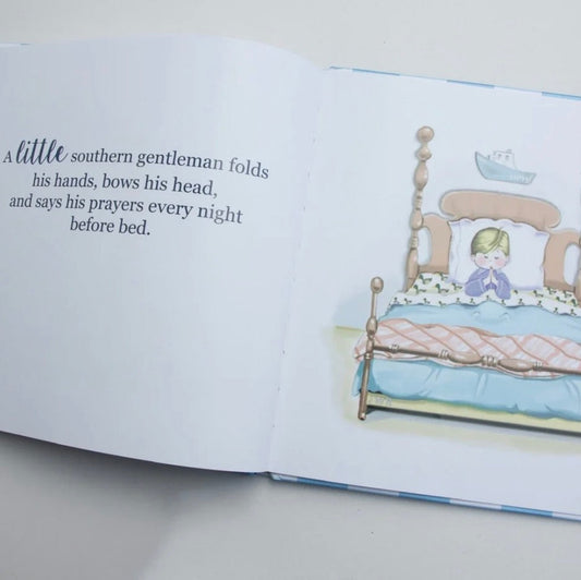 An open children's picture book showing a printed story on the left page and a watercolor illustration of a child in bed on the right page, photographed on a light surface.
