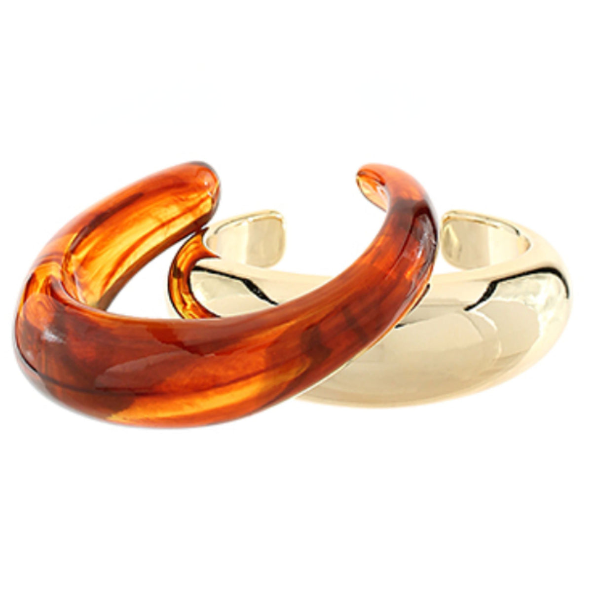 A translucent amber tortoise-pattern open cuff bangle overlapping a polished gold-tone open cuff bangle.