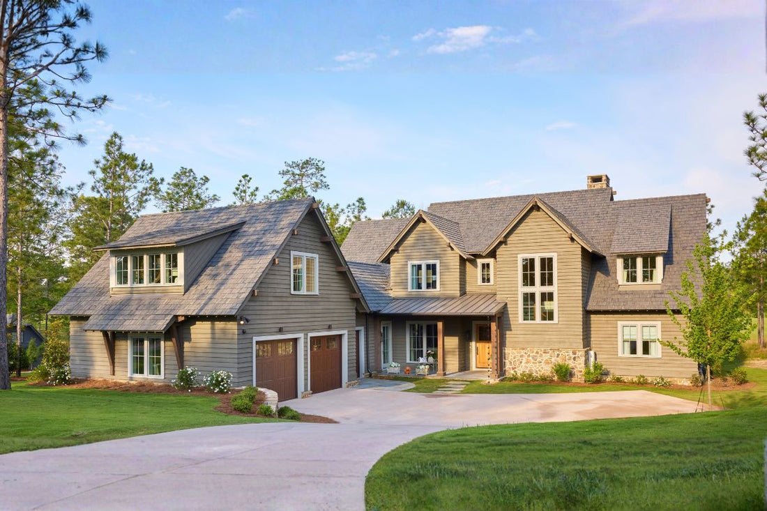 The exterior of a Lake House - two stories with a garage and driveway. 