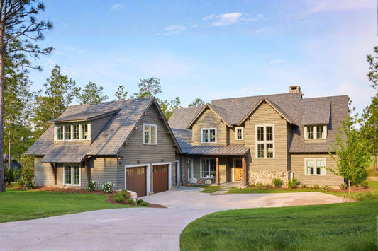 The exterior of a Lake House - two stories with a garage and driveway. 
