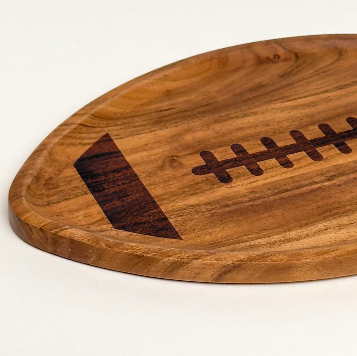 Acacia wood football serving board, close-up of the stitching detail