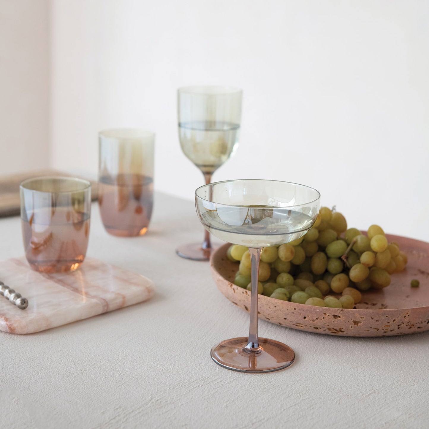 Amber and green iridescent stemmed wine glass, additional styled view.