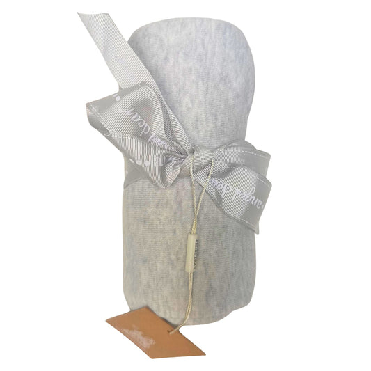 A light gray baby blanket rolled up and tied with a matching gray ribbon bow and featuring a small brown paper tag, shown on a plain white background.