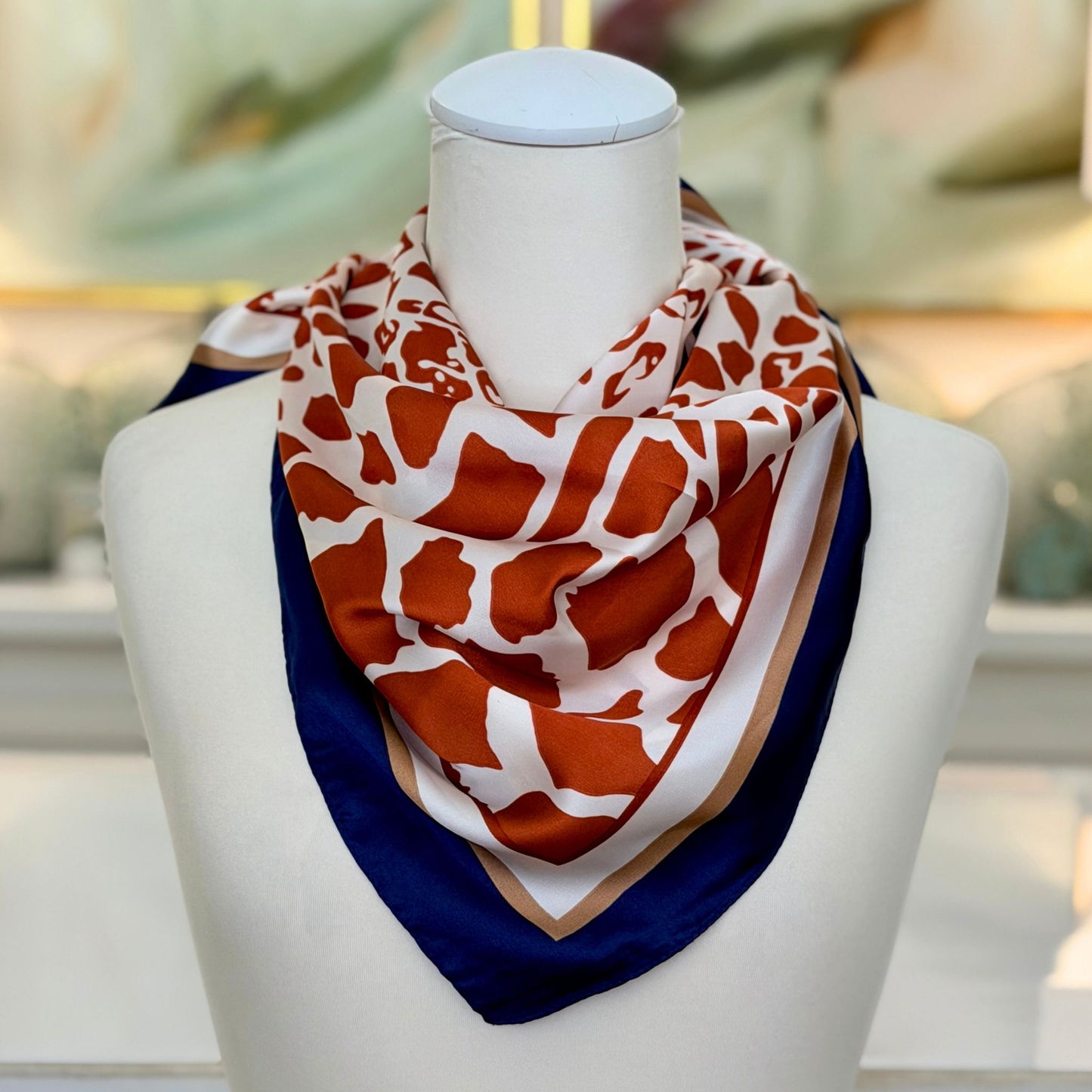 Animal Print Scarf with giraffe pattern, styled on a mannequin bust