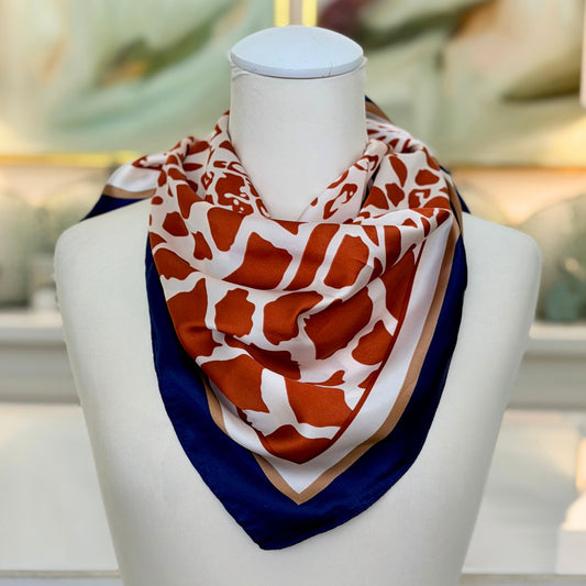 Animal Print Scarf with giraffe pattern, styled on a mannequin bust
