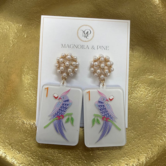 Earrings on a card with 'Magnolia & Pine' branding on a gold surface