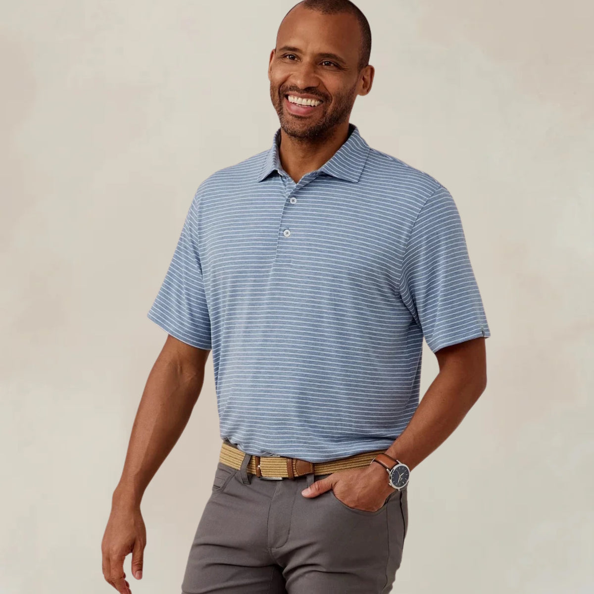 Men's polo shirt in a polar heather and white striped pattern, embroidered with the Lake Martin logo at the chest.