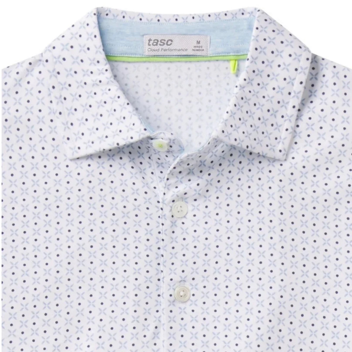 Close-up of the Cambridge print pattern and embroidered Lake Martin logo on the polo's chest.