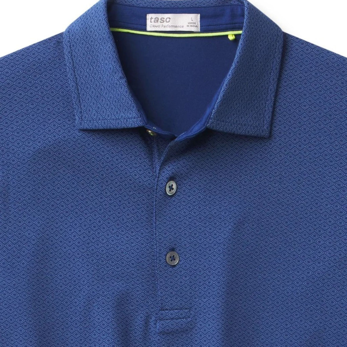 Close-up of the diamond-print pattern and embroidered Lake Martin logo on the polo's chest.