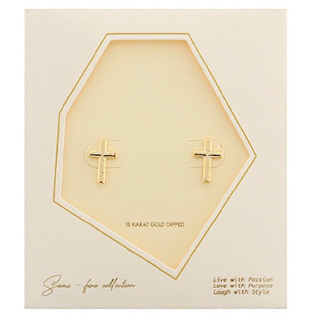 A pair of small gold cross stud earrings displayed on a cream-colored hexagonal card with gold trim. The card includes branding text 'Semi fine collection' and decorative copy at the bottom.