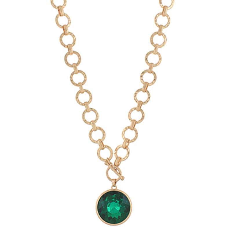 Gold necklace with a green gemstone pendant on a white background