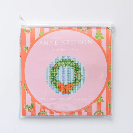 Everlasting Beginner Needlepoint Kit packaging, featuring a holiday wreath design on an orange and pink striped background.