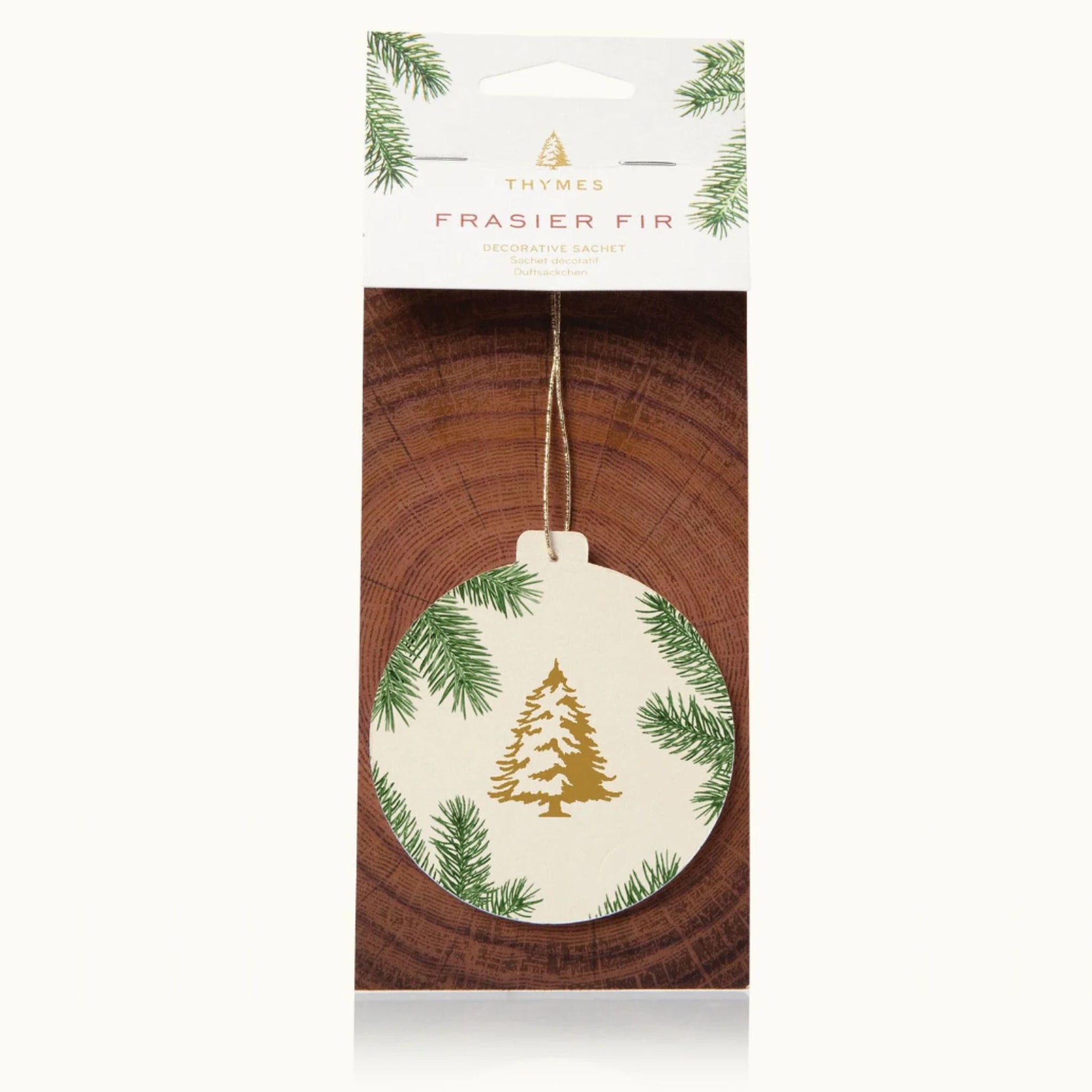 Frasier Fir decorative sachet ornament in its original retail packaging, cream ornament with gold pine tree design