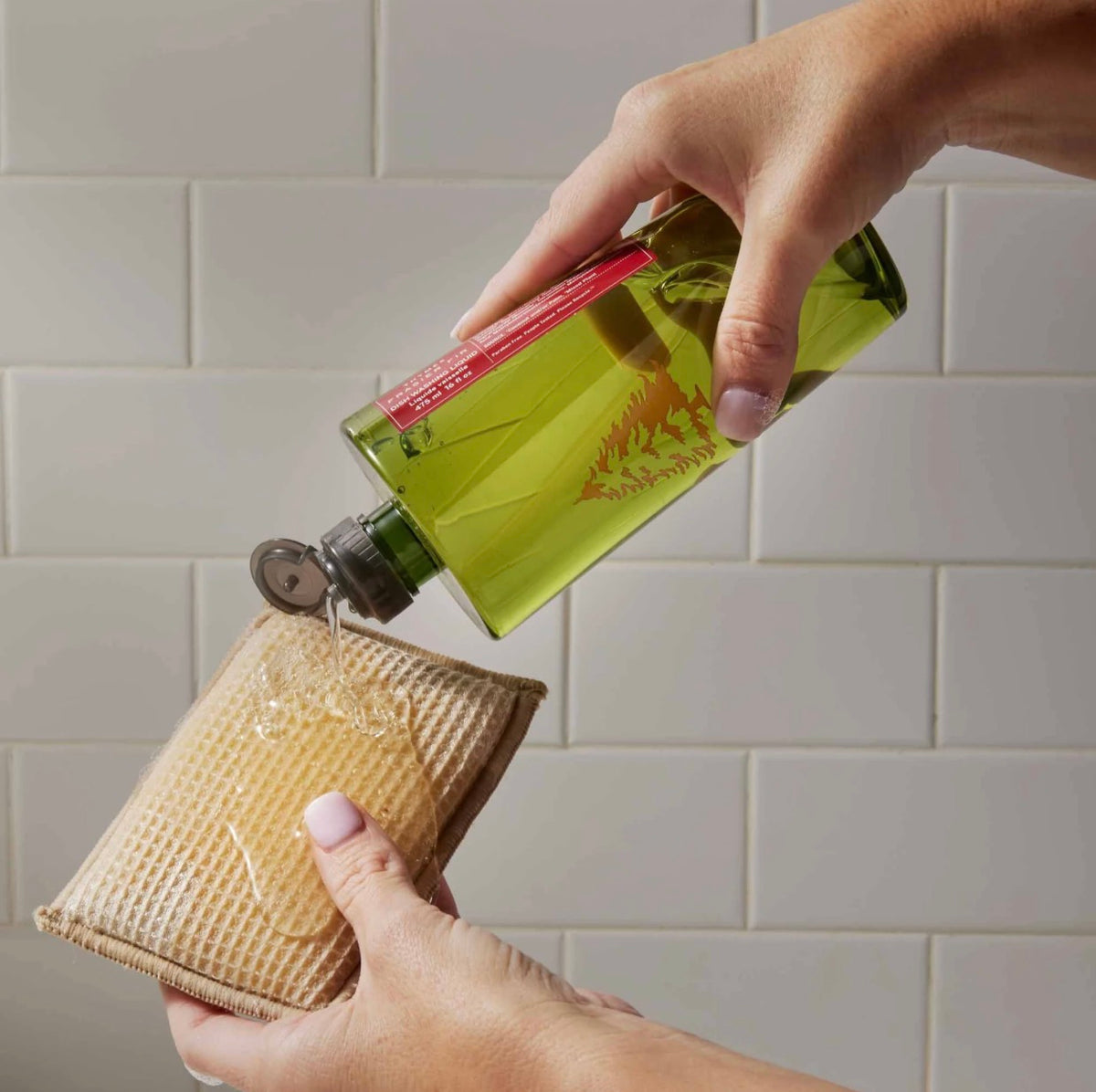 Frasier Fir dish soap bottle, green with a Christmas tree emblem, shown at a different angle.