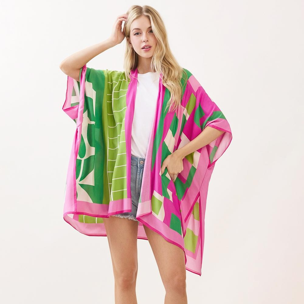 A model wearing the geometric colorblock print kimono in pink, green, and cream, front view.