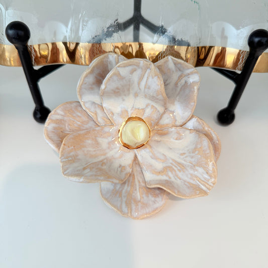 Handcrafted ceramic magnolia flower dish with ivory and cream marbled glaze and a gold-rimmed accent