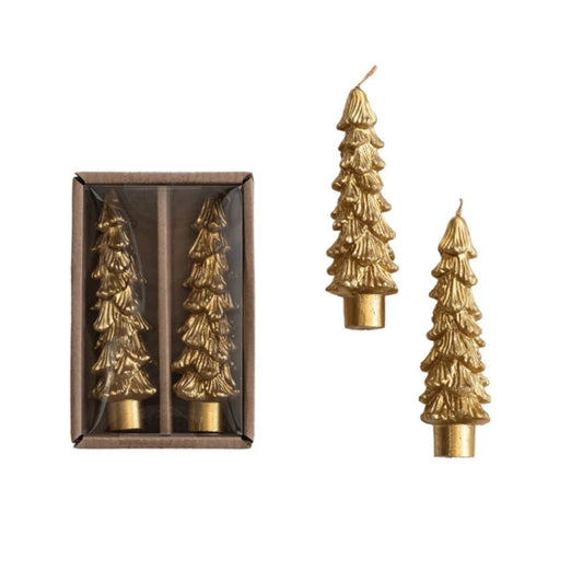 Three gold Christmas tree-shaped taper candles, with two displayed outside and one inside a brown gift box on a white background.