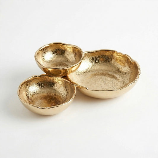 Set of three gold-tone bowls with a subtly textured finish