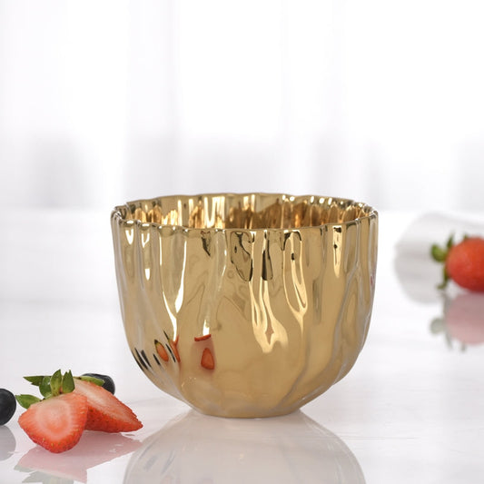 Gold bowl with fruits on a white background