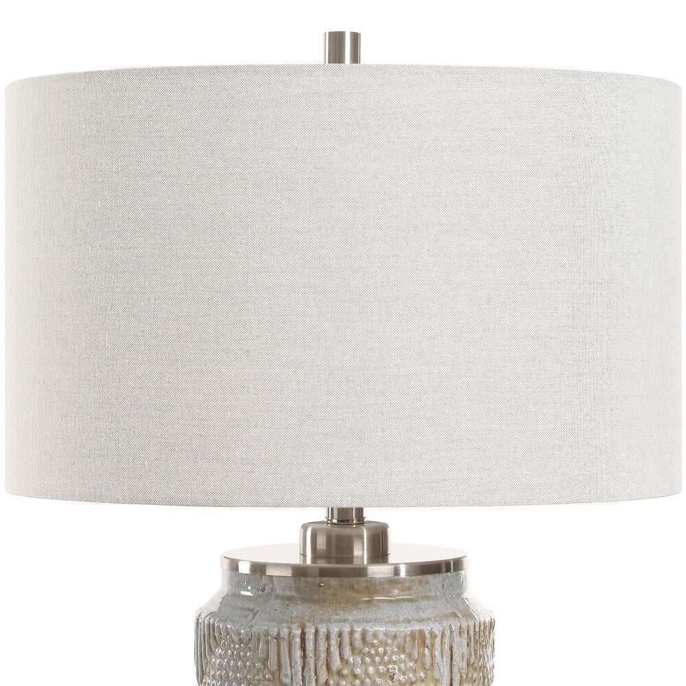 Gray ceramic table lamp with brown patina, close-up of the linen shade