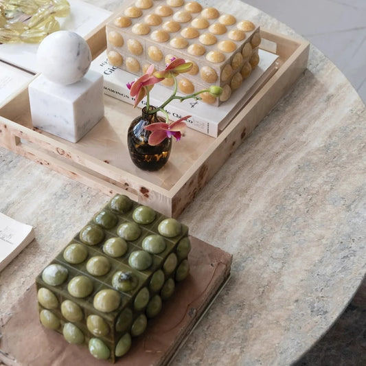 Decorative items on a wooden table with a marble surface