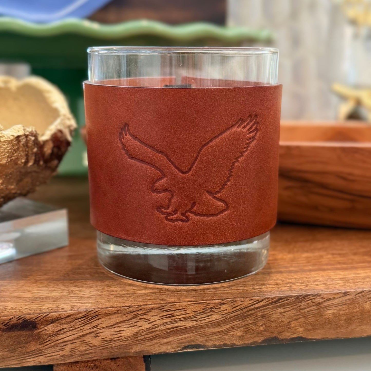 Rocks glass wrapped in leather hand-stamped with a flying eagle design, by Jonathan Davis