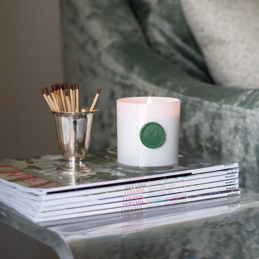 Magnolia & Pine Candle with green wax seal, styled
