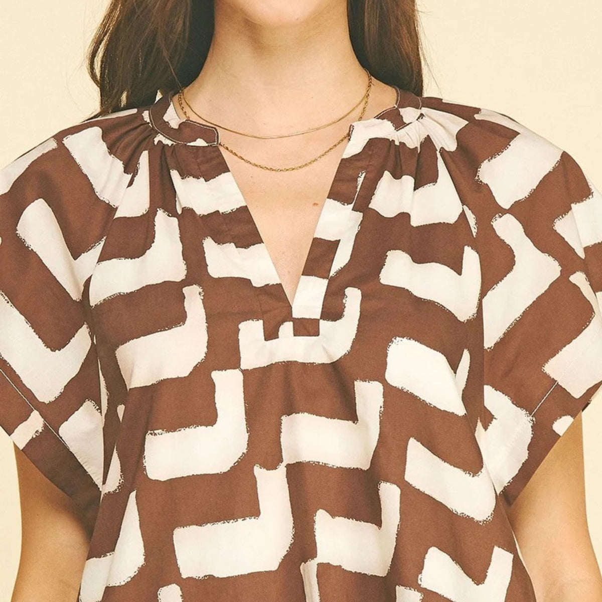 Mini brown geometric print tunic dress, neckline detail