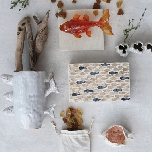 A capiz shell inlaid fish box styled on a console table.