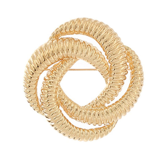 A gold-toned twisted knot brooch with a textured, ribbed finish, photographed on a solid white background.