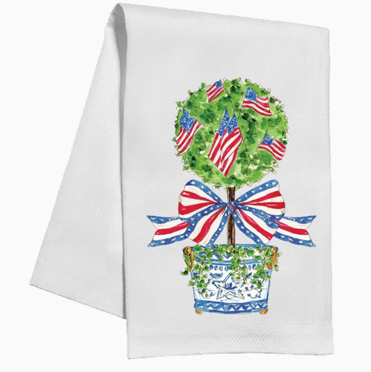 White towel with a decorative topiary design featuring American flags and a bow.