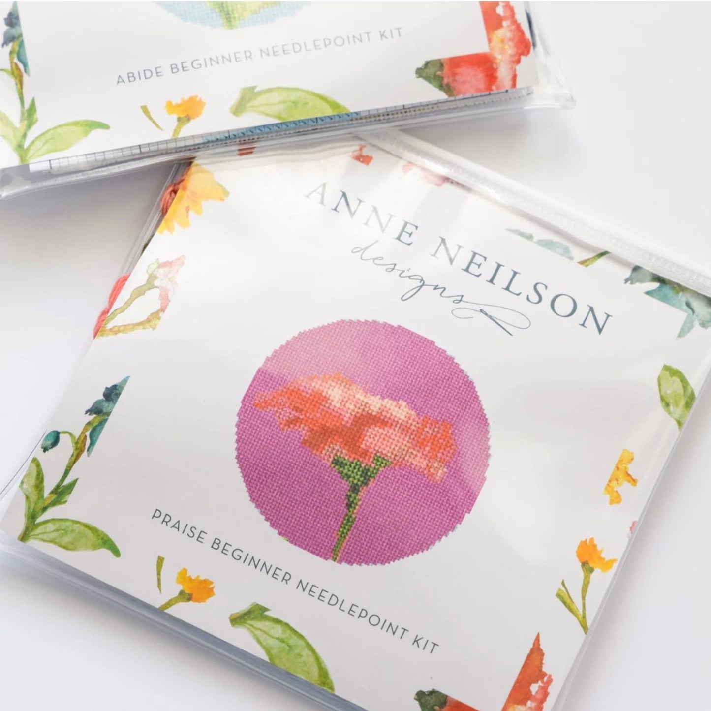 Close-up of the Praise Floral Beginner Needlepoint Kit coral bloom design.