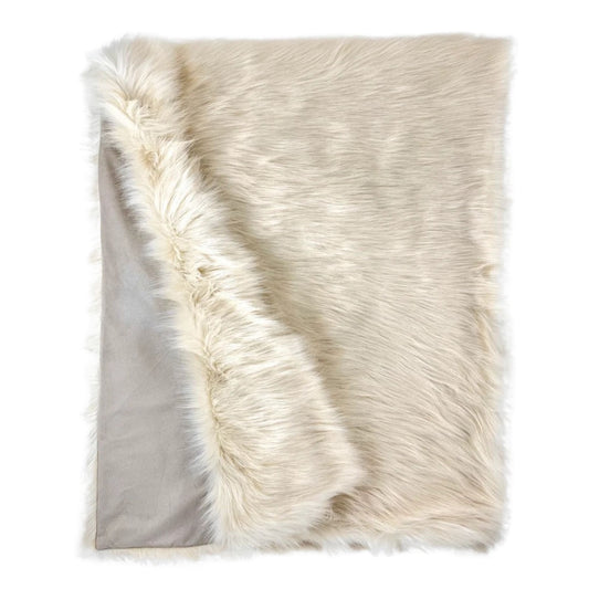 Plush white faux fur throw draped over furniture