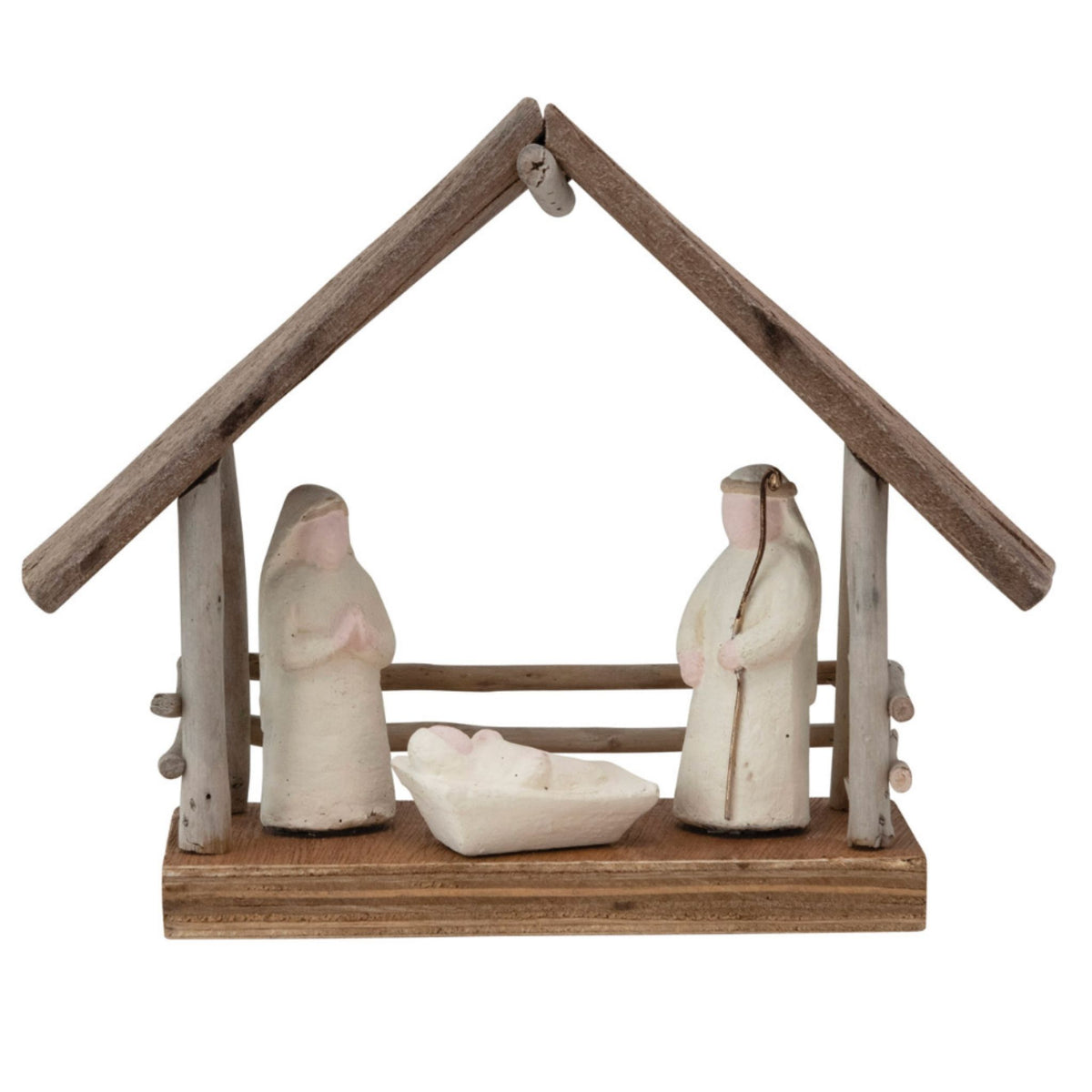 A rustic nativity scene figurine set on a wooden base with a shelter roof. The set includes two standing figures in off-white robes, a small cradle, and weathered brown wood elements.