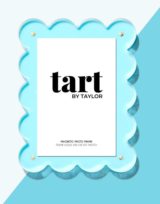 Seafoam scalloped acrylic photo frame, standing on a light blue background