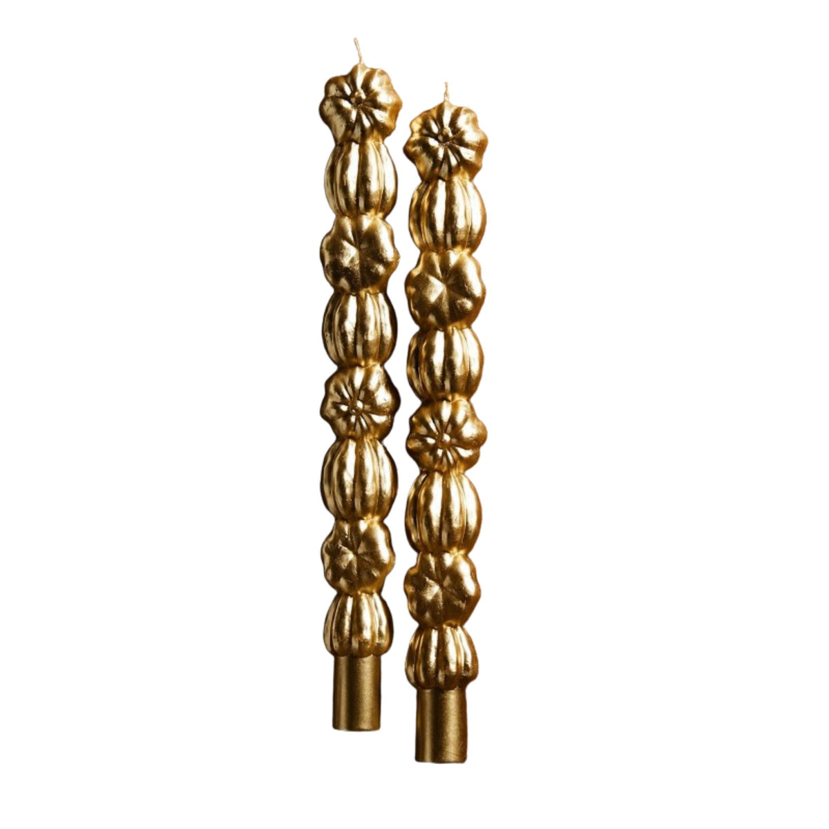 Two tall gold taper candles with a textured, stacked pumpkin design, shown against a plain white background.