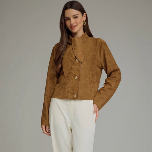 Front view of a cropped camel faux suede jacket with a self-tie neckline and button closure.