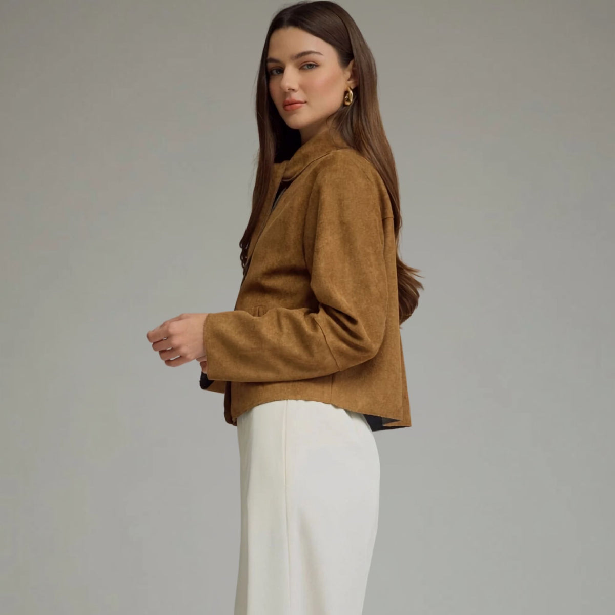 Side view of a cropped camel faux suede jacket.
