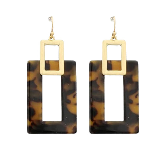 A pair of geometric drop earrings featuring rectangular tortoiseshell resin pendants with cutouts and a gold-tone square frame and fishhook wires above, shown on a plain white background.