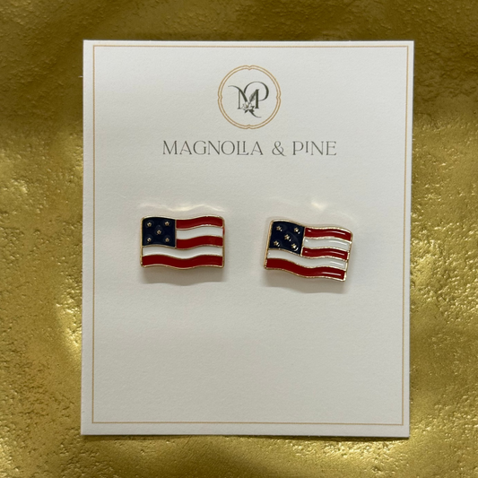 Pair of American flag earrings on a 'Magnolia & Pine' branded card against a gold background